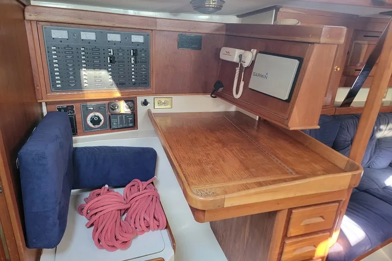 Slide: The Image of Navigation station in a 2002 Tartan 3700 sailboat with control panel and equipment. - 20