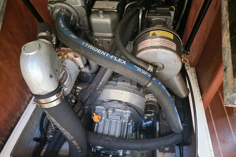 Slide: The Image of Engine compartment of a 2002 Tartan 3700 sailboat, featuring hoses and mechanical components. - 12
