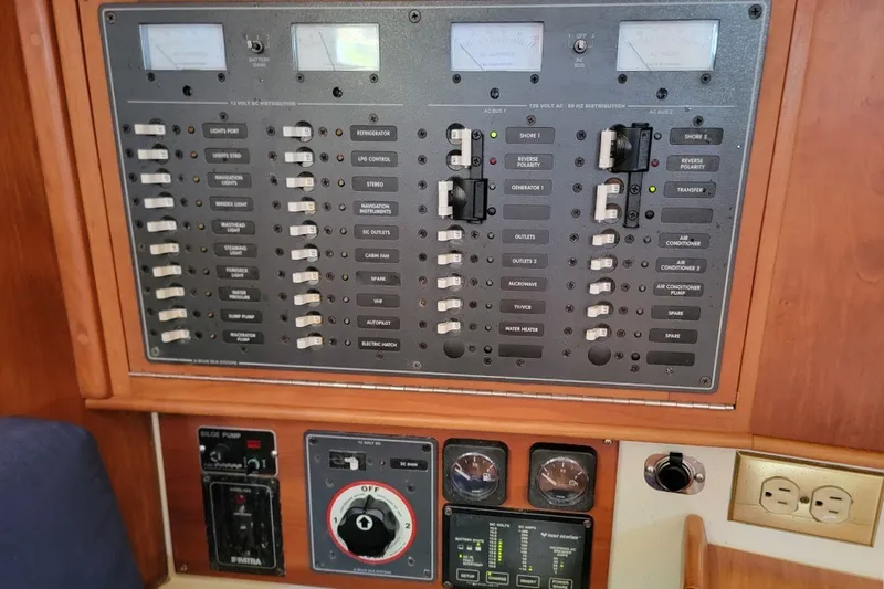 Slide: The Image of Electrical control panel on a 2002 Tartan 3700 yacht, featuring switches and gauges. - 15
