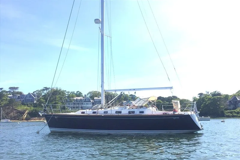 Slide: The Image of Sailboat Tartan 3700, 2002 model, anchored in scenic coastal waters. - 35
