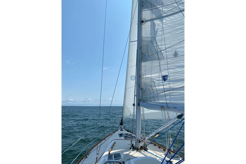 Slide: The Image of Sailing on a 2002 Tartan 3700 yacht with clear blue skies and calm sea. - 36