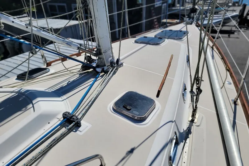Slide: The Image of Deck view of a 2002 Tartan 3700 sailboat, showcasing rigging and hatches. - 23