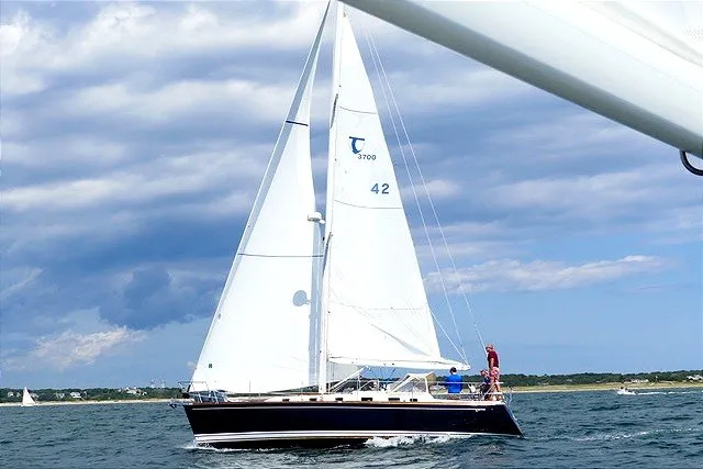 The Image of Sailing yacht Tartan 3700 (2002) on open water under a partly cloudy sky. - 1