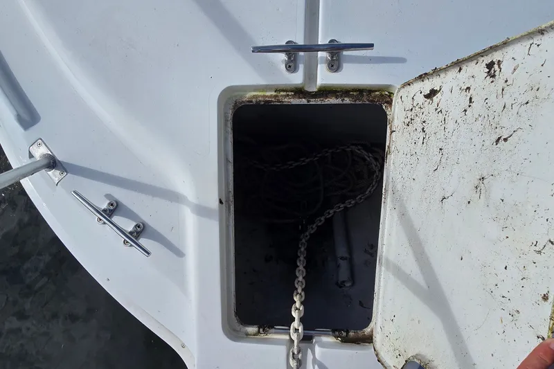 Slide: The Image of Anchor locker of a 1995 Mainship 31 Sedan Bridge with chain and rope. - 13