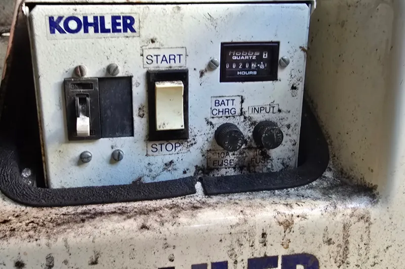Slide: The Image of Control panel of a Kohler generator on a 1995 Mainship 31 Sedan Bridge boat. - 43