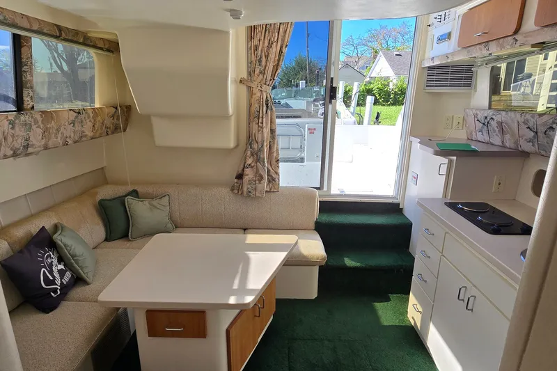 Slide: The Image of Interior of 1995 Mainship 31 Sedan Bridge with cozy seating and kitchenette. - 31