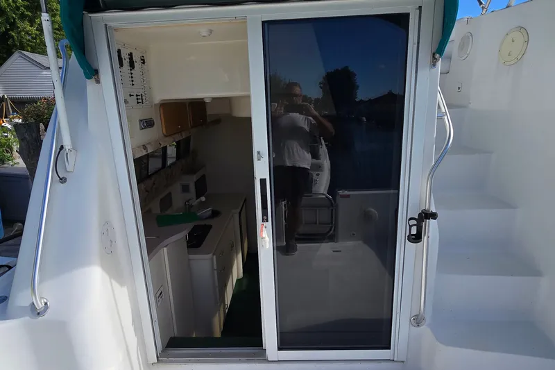Slide: The Image of 1995 Mainship 31 Sedan Bridge interior view through sliding glass door. - 17