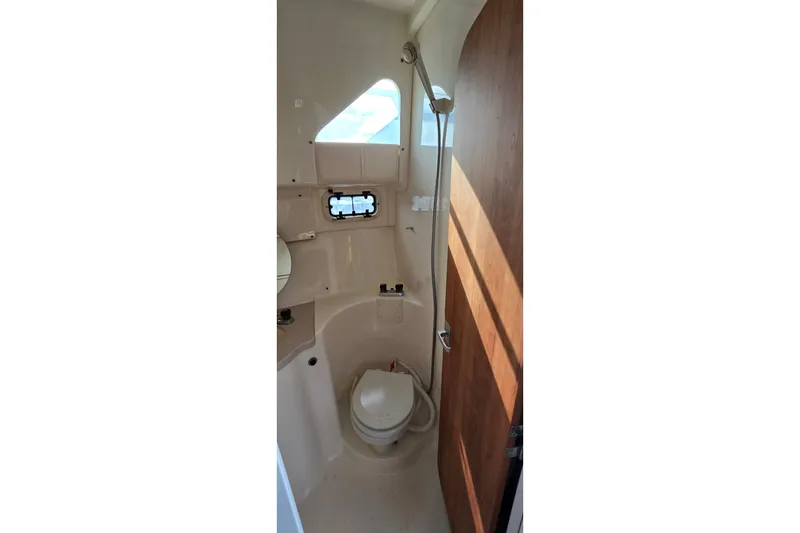 Slide: The Image of Bathroom interior of 1995 Mainship 31 Sedan Bridge with shower and toilet. - 22