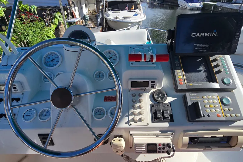 Slide: The Image of 1995 Mainship 31 Sedan Bridge helm with Garmin navigation system and control panel. - 11