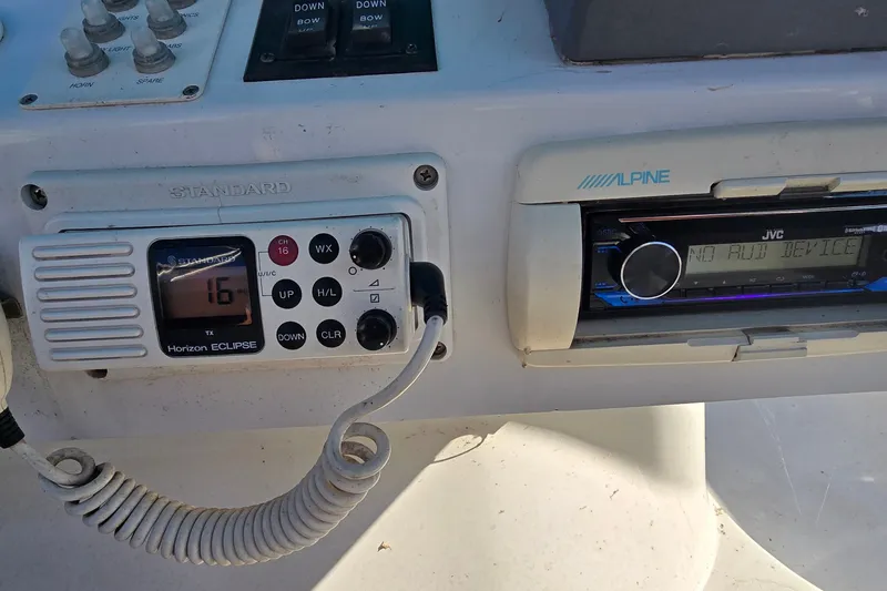 Slide: The Image of Control panel of a 1995 Mainship 31 Sedan Bridge with radio and communication devices. - 14