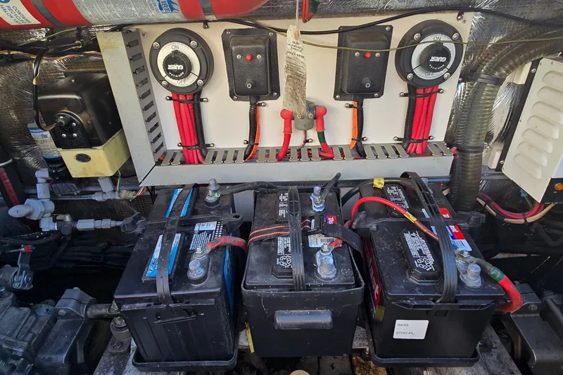 Slide: The Image of Engine room of 1995 Mainship 31 Sedan Bridge with batteries and electrical components. - 42