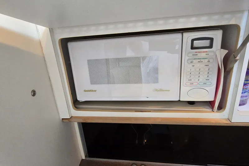 Slide: The Image of GoldStar microwave in a 1995 Mainship 31 Sedan Bridge kitchen cabinet. - 35