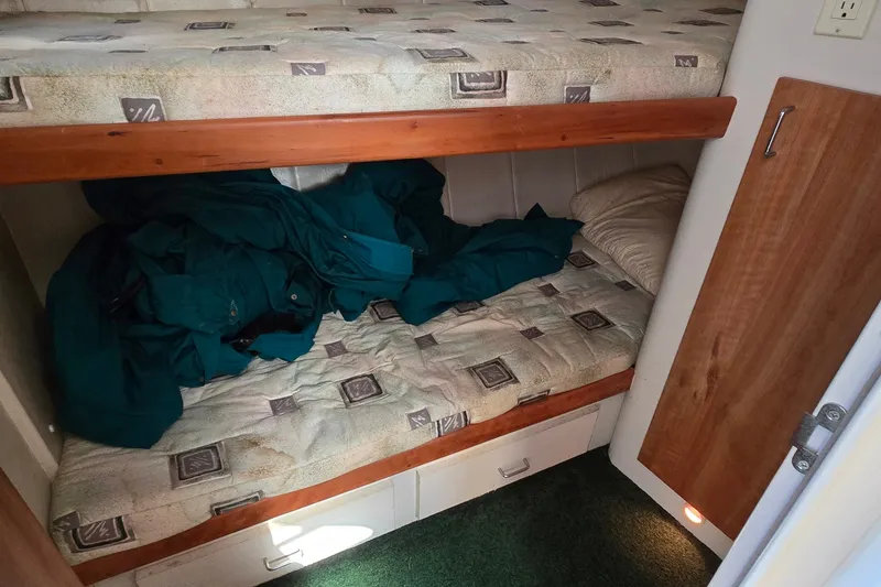 Slide: The Image of Interior cabin of 1995 Mainship 31 Sedan Bridge with bunk beds and storage. - 30