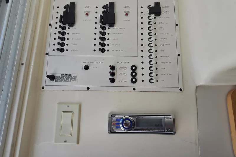 Slide: The Image of Electrical panel and stereo system on a 1995 Mainship 31 Sedan Bridge boat. - 34