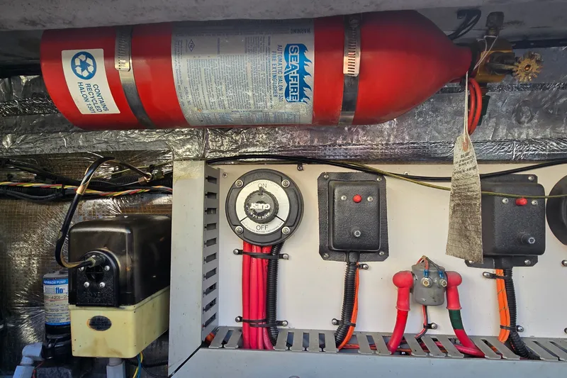 Slide: The Image of Electrical panel and fire extinguisher in 1995 Mainship 31 Sedan Bridge boat. - 39