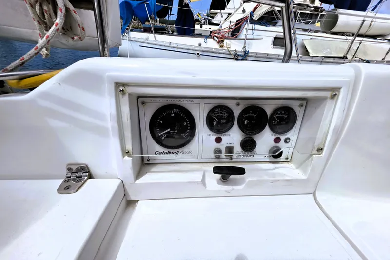 Slide: The Image of Control panel of a 1995 Catalina 30 MkIII sailboat, featuring gauges and switches. - 17
