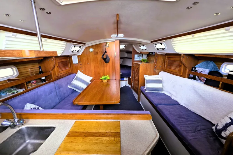 Slide: The Image of Interior of a 1995 Catalina 30 MkIII sailboat with cozy seating and wooden finishes. - 3