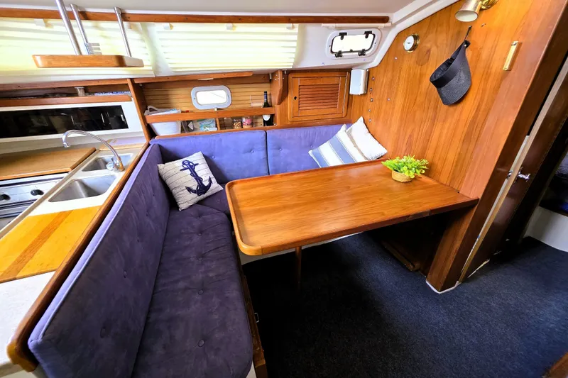 Slide: The Image of Cozy interior of 1995 Catalina 30 MkIII sailboat with dining area and kitchenette. - 5