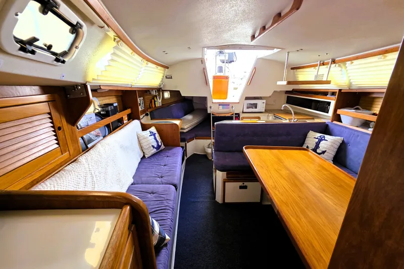 Slide: The Image of Interior of a 1995 Catalina 30 MkIII sailboat with cozy seating and wooden accents. - 12