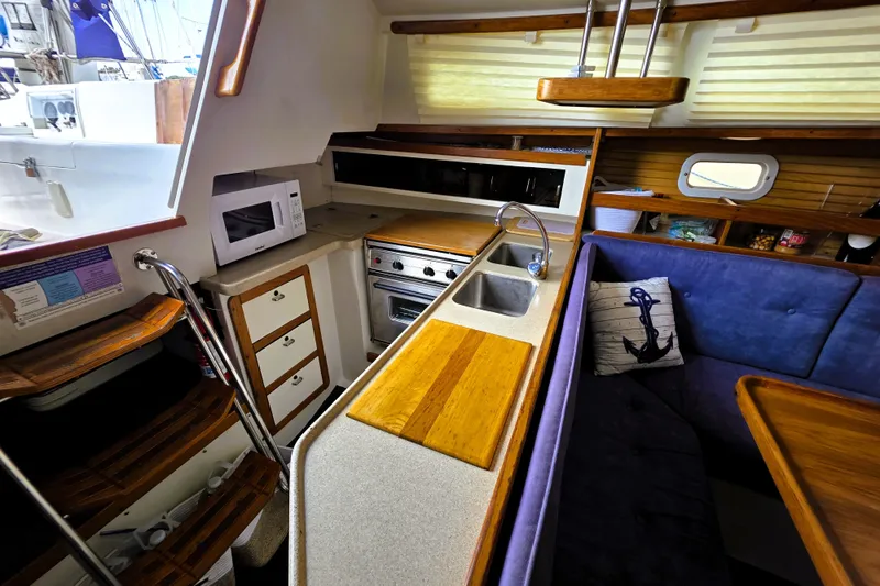 Slide: The Image of Interior of a 1995 Catalina 30 MkIII sailboat with kitchen and seating area. - 4