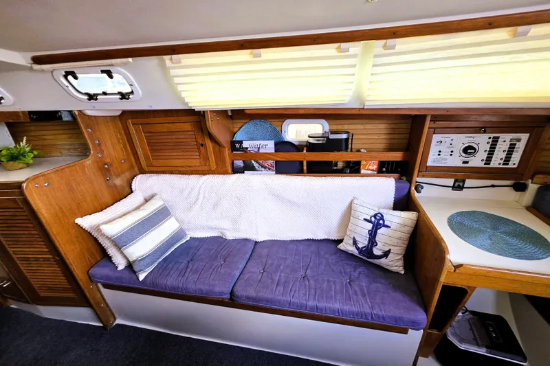 Slide: The Image of Cozy interior of 1995 Catalina 30 MkIII sailboat with cushions and nautical decor. - 8