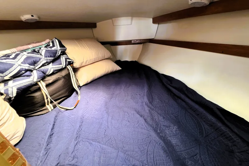 Slide: The Image of Cozy cabin bed in 1995 Catalina 30 MkIII sailboat with pillows and blankets. - 11