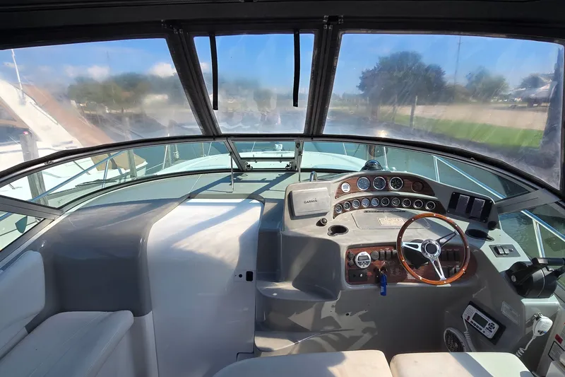 Slide: The Image of Cockpit view of 2000 Four Winns 328 Vista boat with steering wheel and control panel. - 14