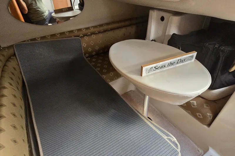 Slide: The Image of Interior of 2000 Four Winns 328 Vista boat with table and "Seas the Day" sign. - 31