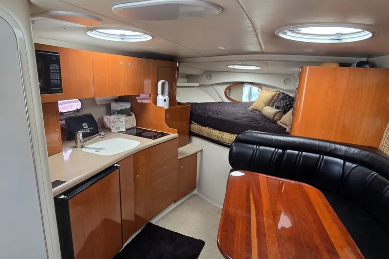 Slide: The Image of Interior of 2000 Four Winns 328 Vista boat with kitchen and cozy sleeping area. - 16