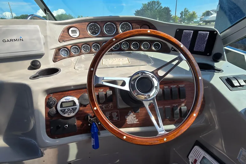 Slide: The Image of Steering wheel and dashboard of 2000 Four Winns 328 Vista boat with Garmin navigation. - 15