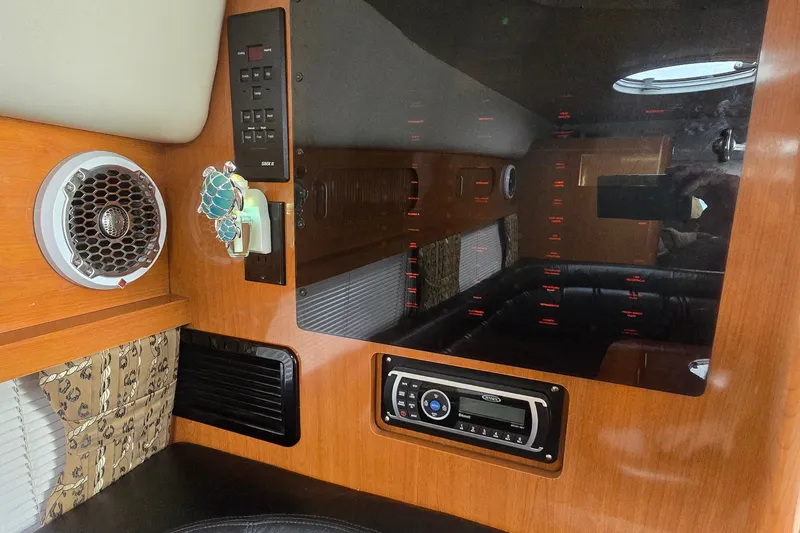 Slide: The Image of Interior of 2000 Four Winns 328 Vista boat with audio system and wood paneling. - 30