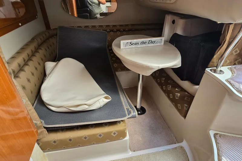 Slide: The Image of 2000 Four Winns 328 Vista cabin interior with seating, table, and nautical decor. - 24