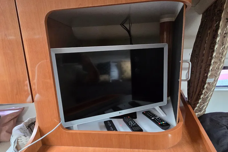 Slide: The Image of LG TV and remotes in 2000 Four Winns 328 Vista boat cabin. - 19