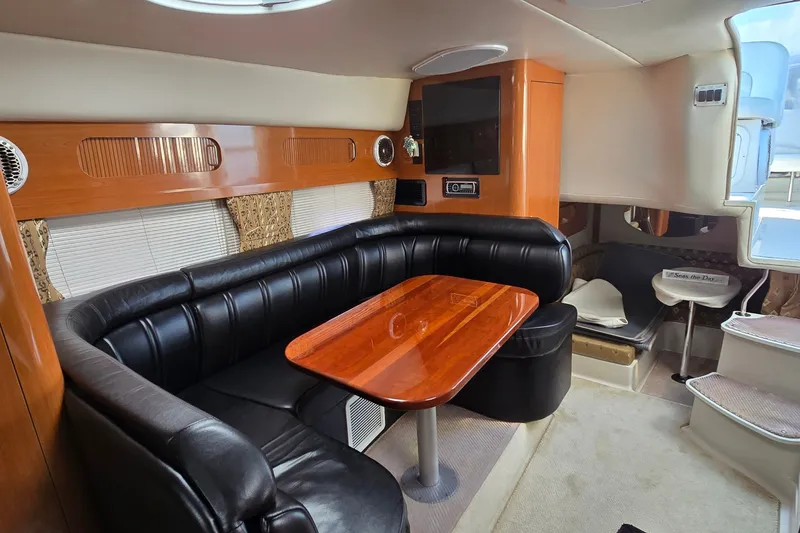 Slide: The Image of Interior of 2000 Four Winns 328 Vista boat with leather seating and wooden table. - 17