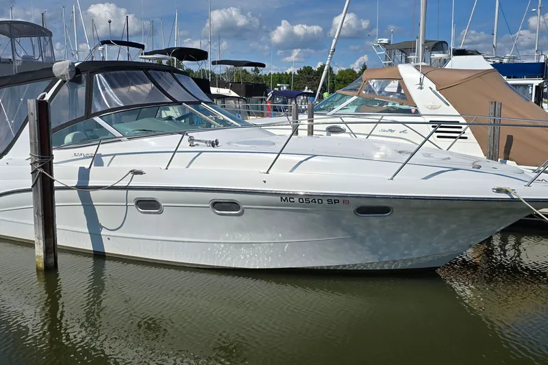 The Image of 2000 Four Winns 328 Vista boat docked in marina under clear blue sky. - 1
