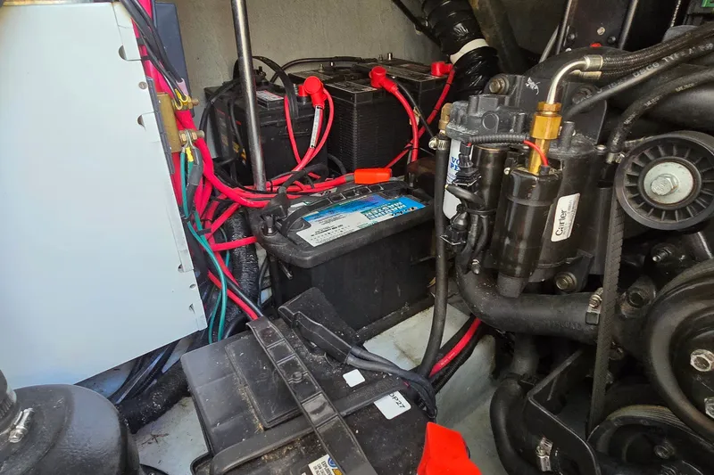 Slide: The Image of Engine compartment of a 2000 Four Winns 328 Vista boat with visible batteries and wiring. - 36