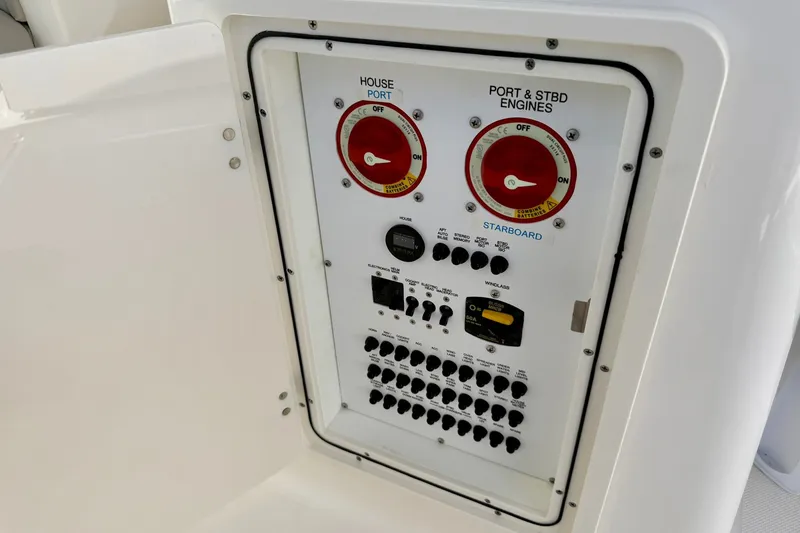 Slide: The Image of Control panel of 2022 Pursuit DC 266 Dual Console boat, featuring switches and dials. - 25