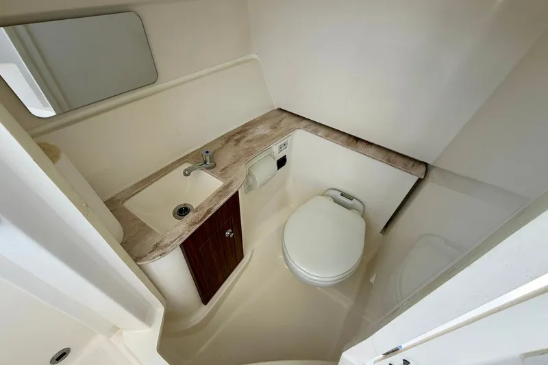 Slide: The Image of 2022 Pursuit DC 266 Dual Console boat bathroom with sink and toilet. - 34