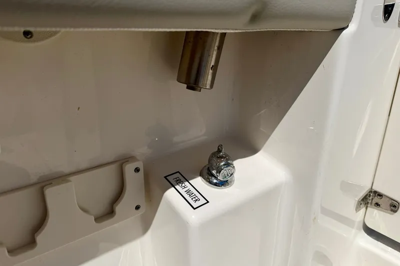 Slide: The Image of Freshwater outlet on 2022 Pursuit DC 266 Dual Console boat. - 15