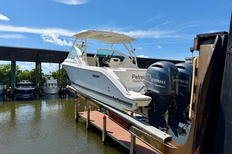 Slide: The Image of 2022 Pursuit DC 266 Dual Console boat with Yamaha engines on a lift. - 41