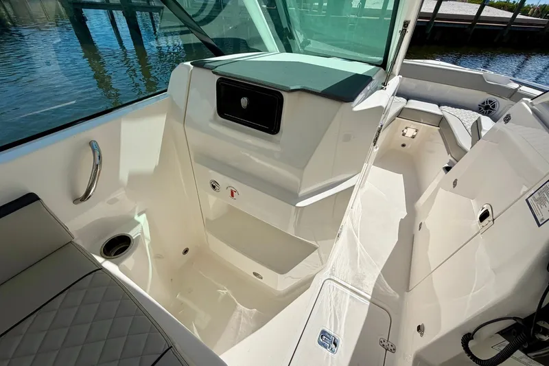Slide: The Image of 2022 Pursuit DC 266 Dual Console boat interior with seating and storage compartments. - 32