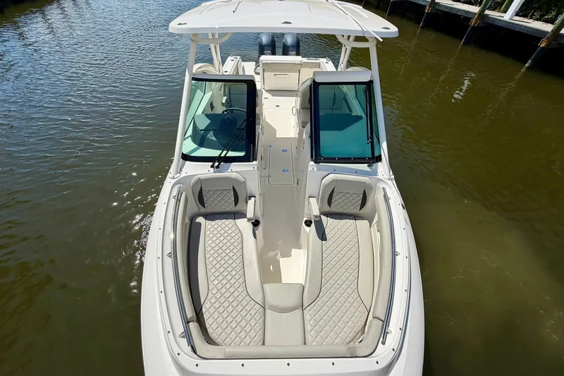 Slide: The Image of 2022 Pursuit DC 266 Dual Console boat on water, featuring spacious seating and modern design. - 36