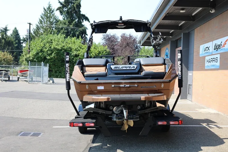 Slide: The Image of Ein Supra SL 550 Boot von 2026 steht auf einem Anhänger vor einem Gebäude. - 5