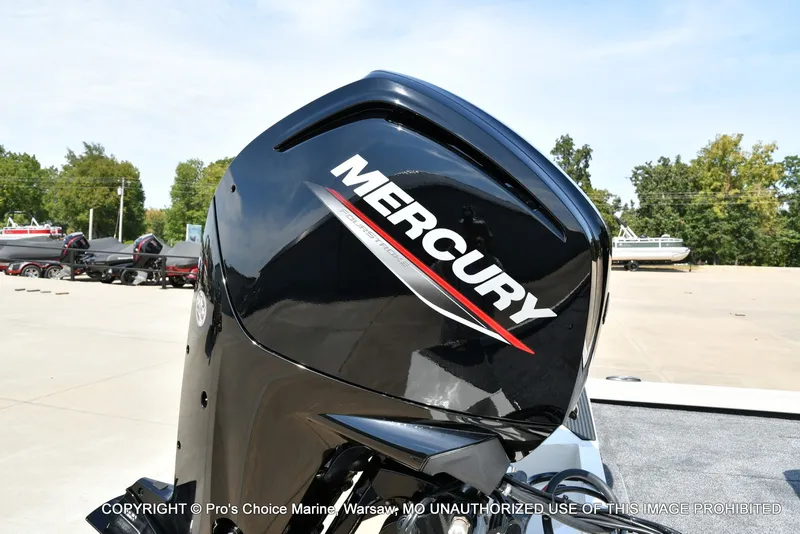 Slide: The Image of A Mercury outboard motor is attached to a boat on a trailer in a parking lot. - 24