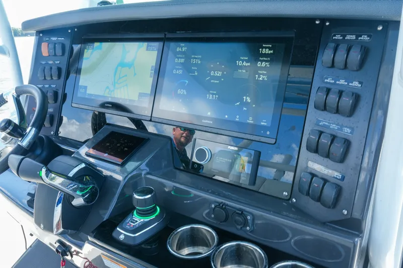 Slide: The Image of 2023 Blackfin 332 CC boat dashboard with navigation screens and control switches. - 41