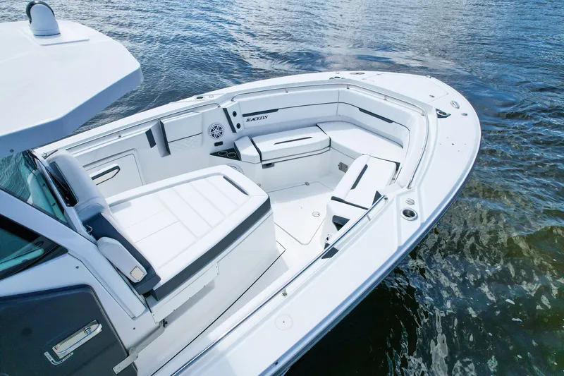 Slide: The Image of 2023 Blackfin 332 CC boat interior with white seating on water. - 8