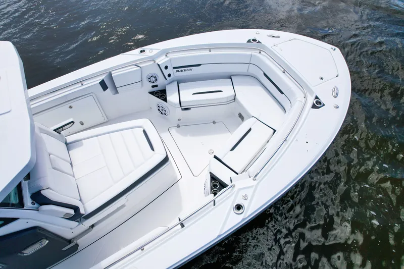 Slide: The Image of 2023 Blackfin 332 CC boat interior with white seating and sleek design on water. - 9