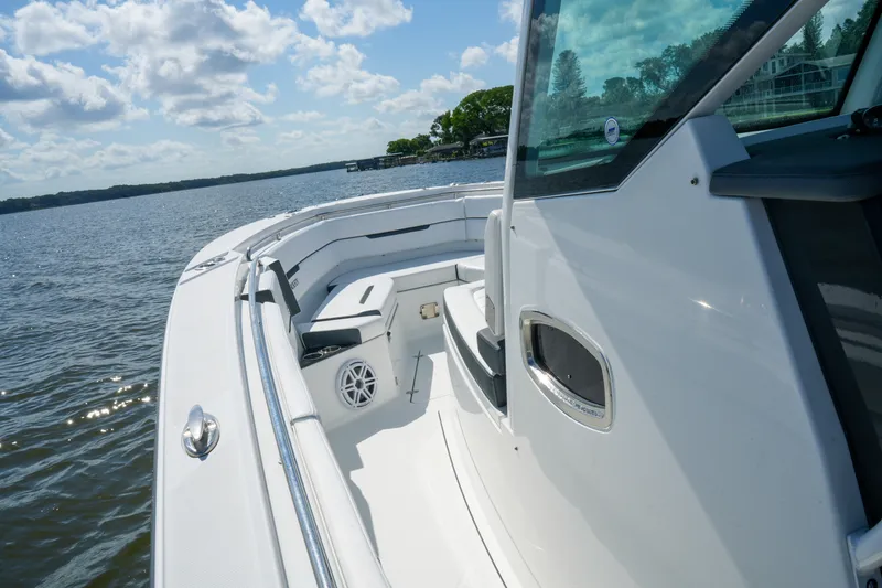 Slide: The Image of 2023 Blackfin 332 CC boat on calm water under a partly cloudy sky. - 32