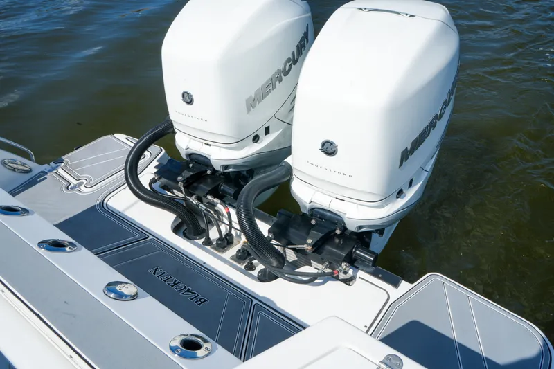 Slide: The Image of 2023 Blackfin 332 CC boat with dual Mercury outboard engines on water. - 26