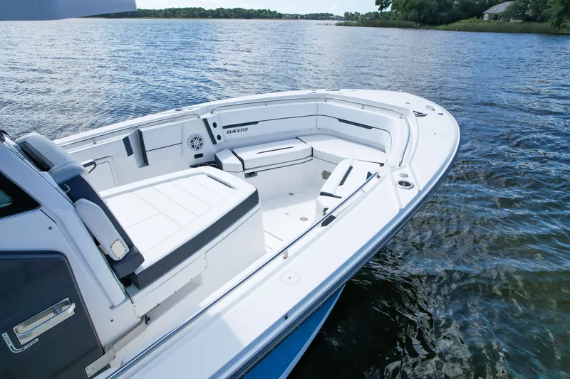 Slide: The Image of 2023 Blackfin 332 CC boat on calm water, showcasing spacious seating and sleek design. - 7